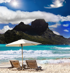 mountain, beach chairs and sea.