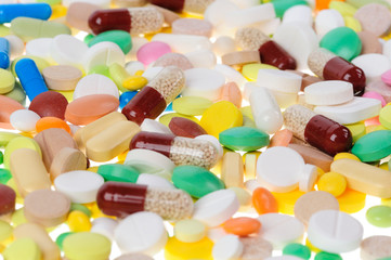 Fototapeta na wymiar Heap of pills on white background