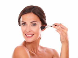 Beautiful female applying facial care product