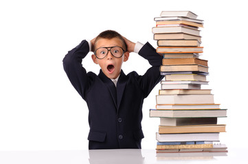 Schoolboy screaming near the huge stack of books