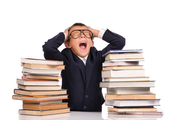 Schoolboy screaming near the huge stack of books