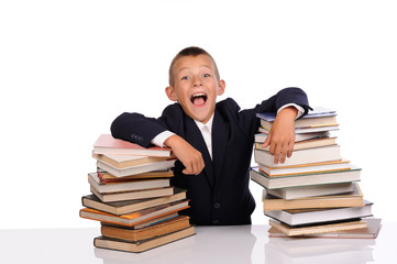 Schoolboy with huge stack of books