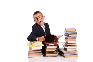 Schoolboy with huge stack of books