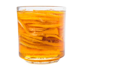 Home remedy of lemon slices and honey in a glass jar over white 