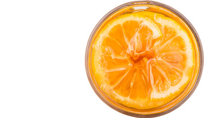 Home remedy of lemon slices and honey in a glass jar over white 
