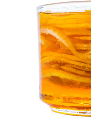 Home remedy of lemon slices and honey in a glass jar over white 
