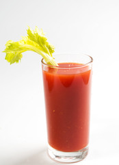 glass of tomato juice decorated with celery
