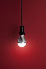 LED bulb on red background
