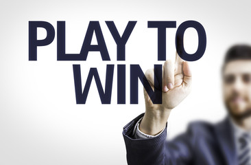 Business man pointing the text: Play to Win