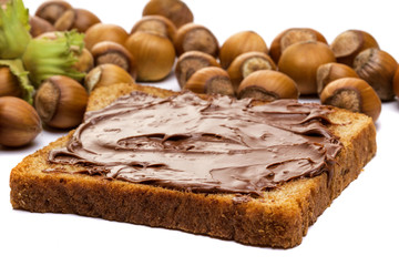 Bread with sweet chocolate hazelnut spread isolated on white