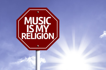 Music Is My Religion written on red road sign