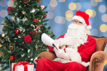 man in costume of santa claus with notepad