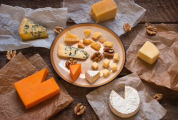 Assorted cheeses on the wooden table