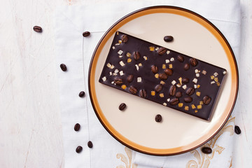 Chocolate with zest and coffee beans on the white table