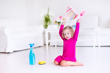 Little girl sweeping the floor