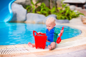 Baby boy playing at a pool