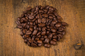 Coffee beans on grunge wooden background