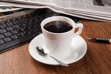 Fototapeta na wymiar cup of coffee and the newspaper