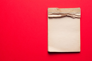 old notebook on red background