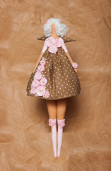 Handmade doll on paper background, Tilda 