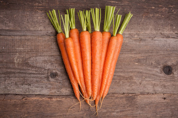 fresh carrot bunch on grungy wooden background