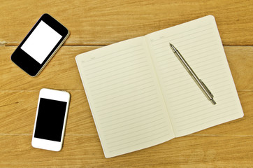 notebook and pencil on wooden background
