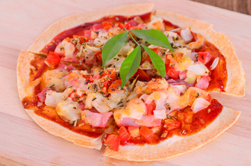 Tortilla pizza with mozzarella cheese, pepper, and basil on the