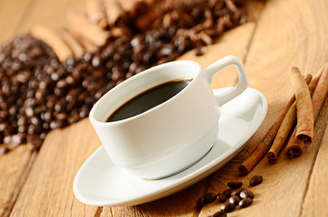Coffee cup and coffee beans around