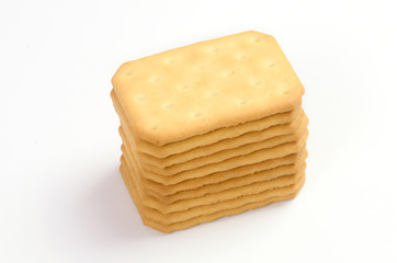 Salty crackers in square shape on white background