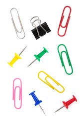 pushpin and paper clip on white