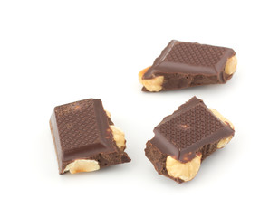 Stack of chocolate pieces with nut isolated on white background