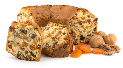Sliced fruit cake isolated on white background