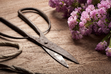 Old Vintage steel scissors on wooden table  with flower