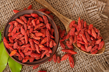 Red dried goji berries in wooden spoon