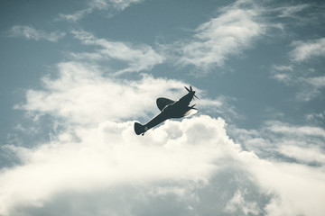 Fighter plane on cloudy sky