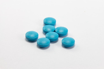 Blue tablets pills heap mix on white isolated background