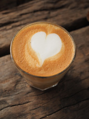coffee latte on the wood desk vintage color tone