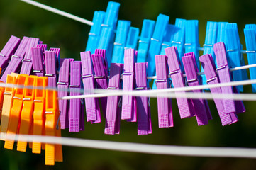 many colorful clothespins on a rotary clothes dryer