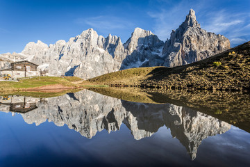Pale di st Martino reflecting on a lake  Italian Dolomites Alps