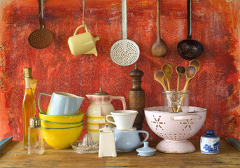 collection of vintage kitchenware, red background