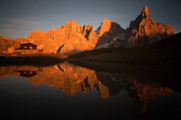 Fototapeta na wymiar Pale di st Martino reflecting on a lake Italian Dolomites Alps