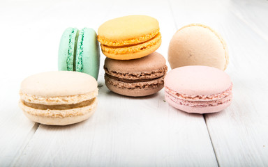 Set of macarons on white wooden table