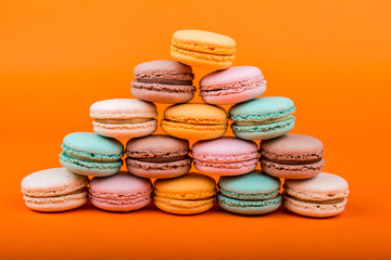 Set of macarons on orange background