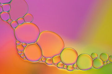 colorful drops of oil and air bubbles on the water