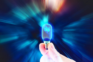 hand hold light bulb on motion zoom lighting,technology idea