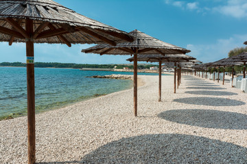 Parasols, beach Vir, Croatia