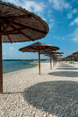 Parasols, beach Vir, Croatia