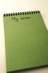 Hand drawing aims list on notebook