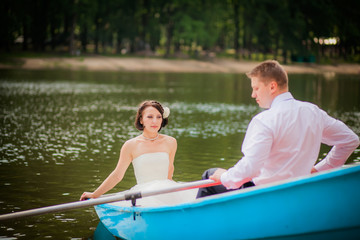 Fototapeta premium beautiful newlyweds in wedding day in a boat