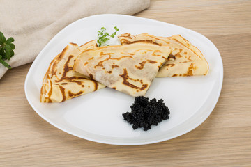 Pancakes with black caviar